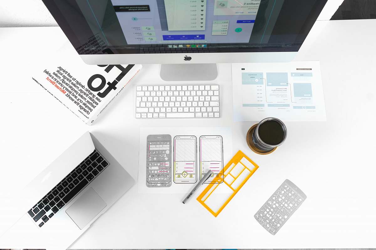 keyboard silver MacBook Air on table near iMac hardware